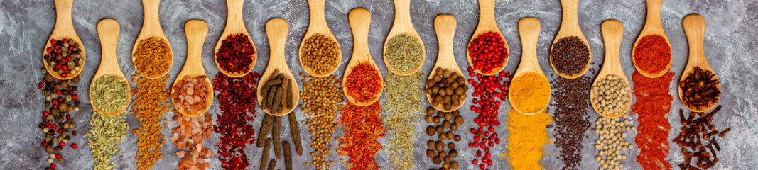 A set of spices on a gray background. Variety of spices from India. Food decoration design. Various...