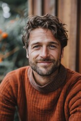 Obraz premium Handsome smiling, happy and pleased stoic man with positive vibes. Portrait of a joyful young man with beautiful hair and fashionable clothes.