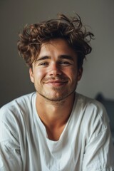 Handsome smiling, happy and pleased stoic man with positive vibes. Portrait of a joyful young man with beautiful hair and fashionable clothes.