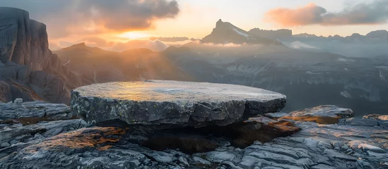 Foto auf Acrylglas An outdoor rock table top with a mountain landscape at sunrise showcasing organic beauty and natural tranquility. © NE97