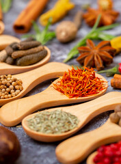 A set of spices on a gray background. Variety of spices from India. Food decoration design. Various spices, peppers and herbs close-up top view. Set of peppers, salt, herbs and spices for cooking.