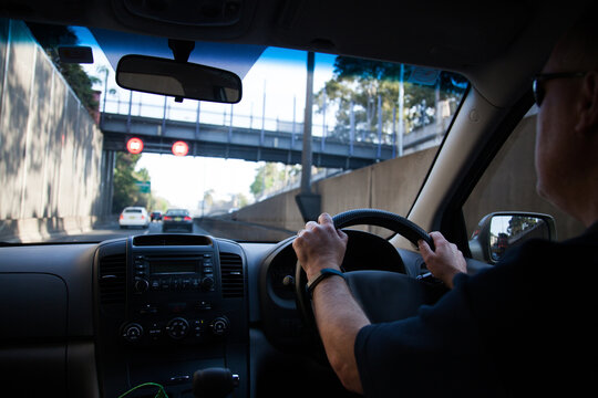 Man driving car through city