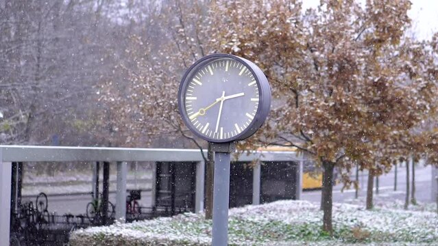 Modern architecture. Clock at the station on a snowy day.