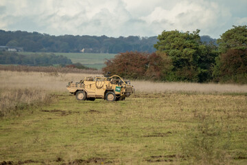 Fototapeta premium close-up of a British army Supacat Jackal 4x4 rapid assault, fire support and reconnaissance vehicle, in action on a military exercise, Wilts UK