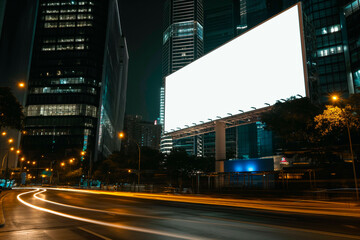 Fototapeta na wymiar Blank white road billboard with KL cityscape background at night time. Street advertising poster, mock up, 3D rendering. Front view. The concept of marketing communication to promote or sell idea.