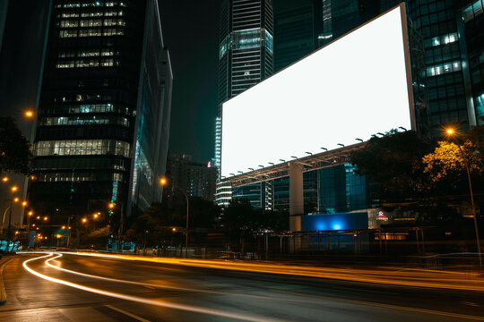 Blank white road billboard with KL cityscape background at night time. Street advertising poster, mock up, 3D rendering. Front view. The concept of marketing communication to promote or sell idea.