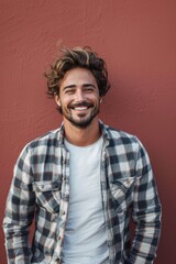 Fototapeta premium Handsome smiling, happy and pleased stoic man with positive vibes. Portrait of a joyful young man with beautiful hair and fashionable clothes.