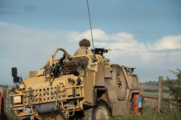 close-up of a British army Supacat Jackal 4x4 rapid assault, fire support and reconnaissance vehicle, in action on a military exercise, Wilts UK