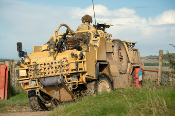 Fototapeta premium close-up of a British army Supacat Jackal 4x4 rapid assault, fire support and reconnaissance vehicle, in action on a military exercise, Wilts UK