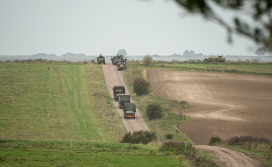 a convoy of British army utility vehicles in action on a military exercise, Wilts UK