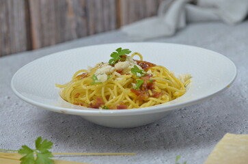 traditional italian food, spaghetti carbonara with bacon and egg and parmesan cheese
