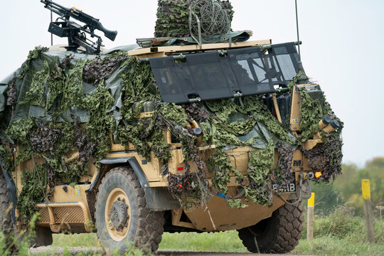 British army Supacat Jackal 4x4 rapid assault, fire support and reconnaissance vehicle with camouflage, in action on a military exercise, Wilts UK