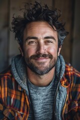 Obraz premium Handsome smiling, happy and pleased stoic man with positive vibes. Portrait of a joyful young man with beautiful hair and fashionable clothes.