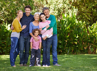 Fototapeta premium Family, portrait and hug in outdoor nature, love and bonding together or happy in backyard. Generations, smile and peace or embrace for support in garden or park, vacation and holiday in France