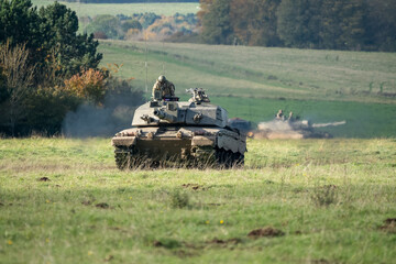 Commander and gunner directing a British army Challenger 2 II FV4034 main battle tank in action on...
