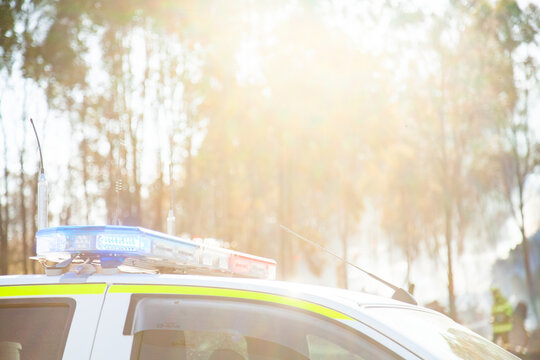 Red and blue flashing lights on top of emergency service vehicle