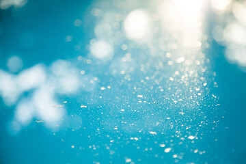 Dust on blue water in backyard pool, blue texture background