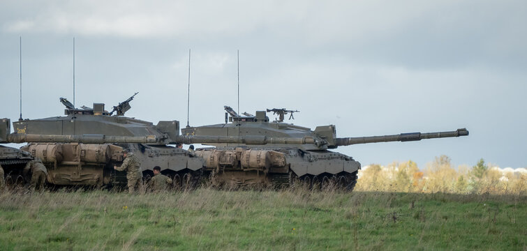 close-up of several British army Challenger 2 FV4034 battle tanks, guns targetted