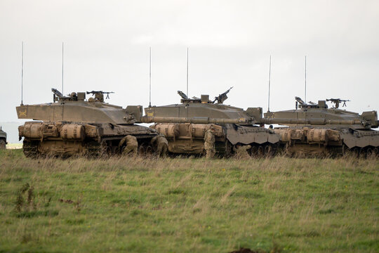 close-up of several British army Challenger 2 FV4034 battle tanks, guns targetted