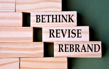 BETHINK REVISE REBRAND - words on wooden blocks on dark green background
