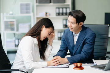Asian business team and lawyers discussing contract papers sitting at the table. Concepts of law, advice, legal services.