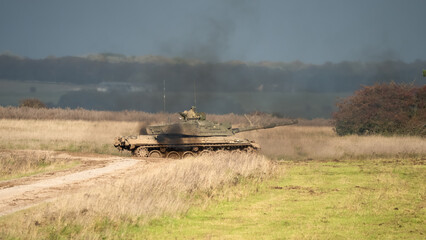 Fototapeta na wymiar Commander and gunner directing a British army Challenger 2 II FV4034 main battle tank in action on a military exercise
