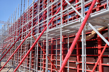 Vertical panel formwork, push-pull jacks and scaffoldings of reinforced concrete walls under construction. Structures for cast in place reinforced concrete