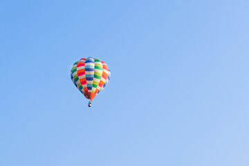 Hot air balloons landing in a mountain flight over field and forest,colorful Hot air balloons flying over the valley with blue sky,Tourism concept.