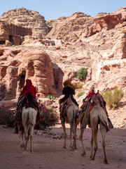 Bedouins riding on camel back in Petra