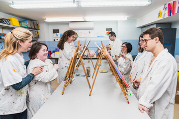 Individuals with Down Syndrome enjoy a creative painting session, expressing freely.