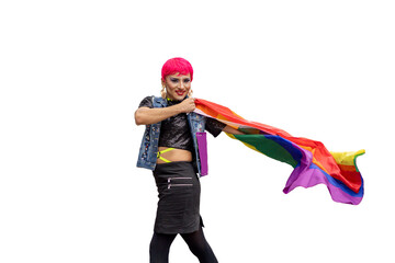 A transgender person with pink hair and a rainbow flag in his hand