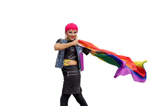 A transgender person with pink hair and a rainbow flag in his hand