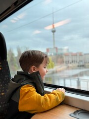 child looks out the train window