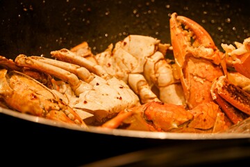 A pan of food with a variety of seafood including shrimp and crab