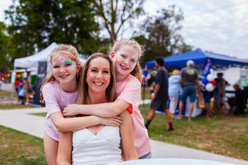 Portrait of Aussie mum and two daughters together at summer time event