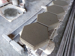 Many hexagonal cement brick flooring are stacked in construction supply stores.