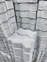 Many cement brick flooring are stacked in construction supply stores.