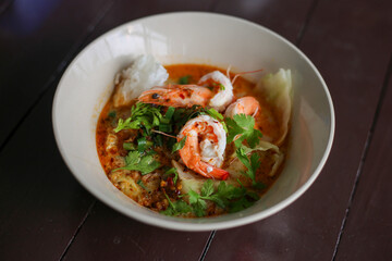 selective focus shrimp looks delicious in a bowl of tom yum shrimp noodles Placed on the table to decorate the table. cooking ideas
