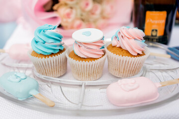 a Pastel cupcakes and popsicles on display for a celebration