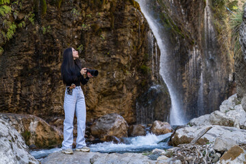 Photographer woman explores new, fantastic places around the world. Female hiker crossing the...
