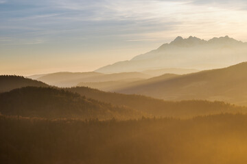 Evening landscape.. There is fog in the valley. View of the Tatra Mountains from the Pieniny Mountain Range. Slovakia.