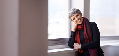 Fototapeta premium Portrait, smile and senior woman in house, home or apartment by window for retirement in Australia. Face, elderly and happy person with confidence or pensioner in casual clothes with mockup space