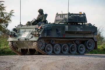 soldier commanding a british army Bulldog FV432 tank in motion, Wiltshire UK