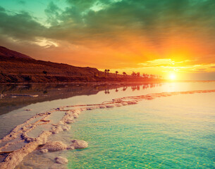 Seascape in the morning. Orange sunrise over the Dead Sea