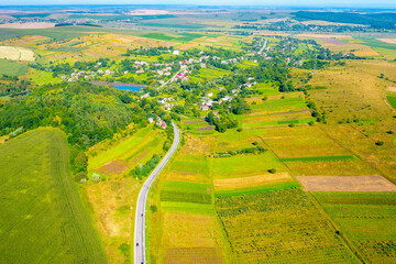 Sunny day in the countryside. Rural landscape in daylight. Aerial view of the highway among the fields - 759686465