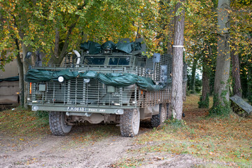 close-up of a British army Mastiff protected patrol vehicle amongst woodland