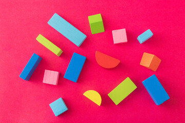 Fototapeta na wymiar Colorful Wooden Toy Blocks On red Background