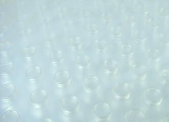 Pattern of top of a new plastic water bottle wrapped in plastic is cloudy.