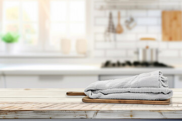 Grey dish towel on kitchen wood bench for product mockup with empty blank copy space blur...