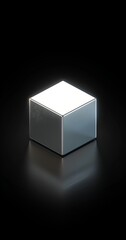 A simple, minimalistic silver cube icon with a soft light on the right side on a black background.